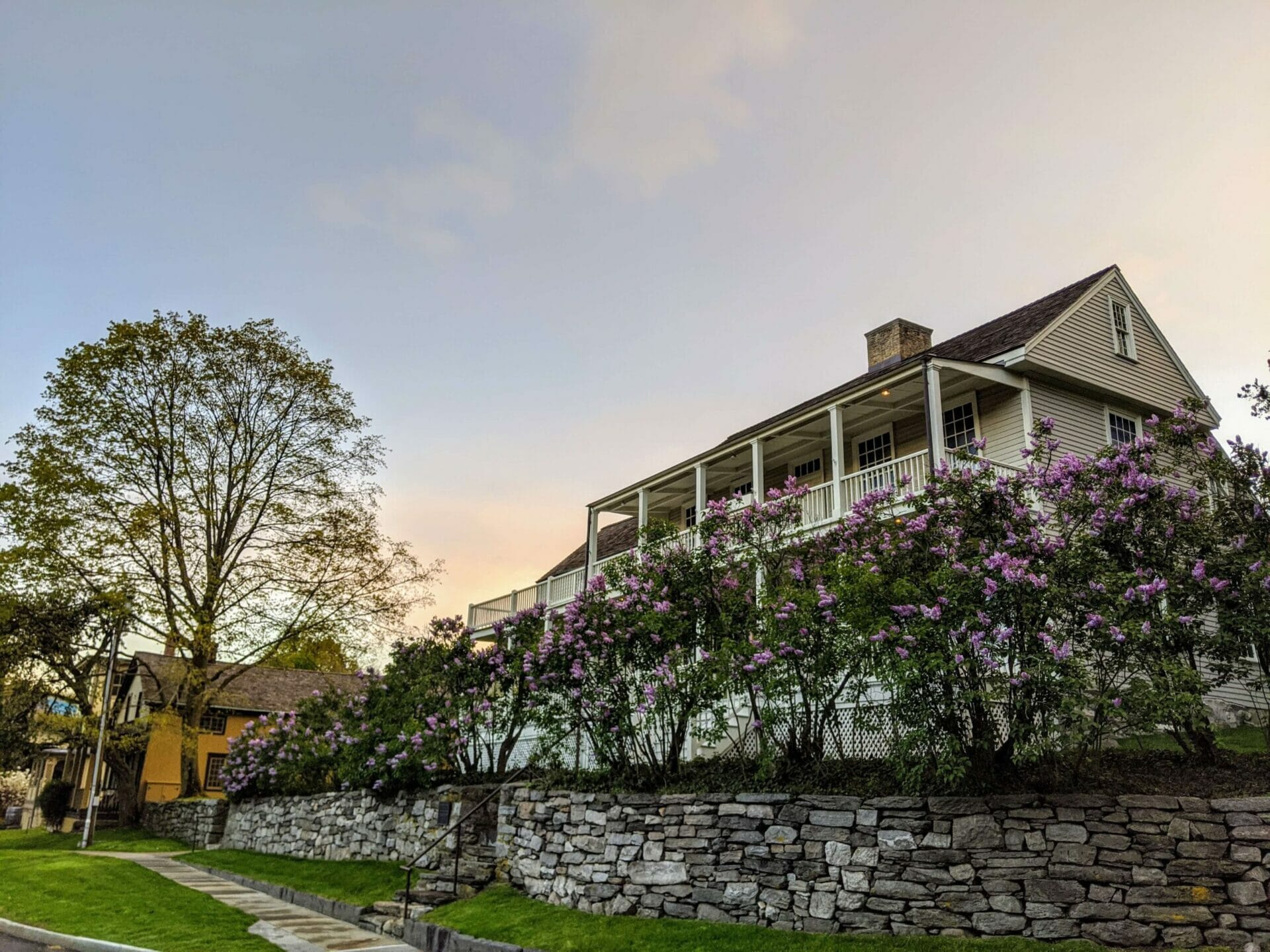 Bush-Holley house surrounded by lilacs at sunset