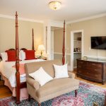 Another view of the queen bed, antique dresser, and butler's pantry in Room 28