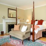 Fireplace and four-poster queen bed in Room 28