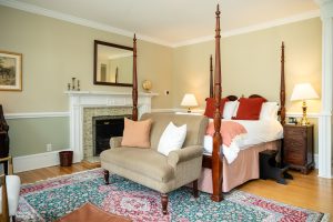 Fireplace and four-poster queen bed in Room 28