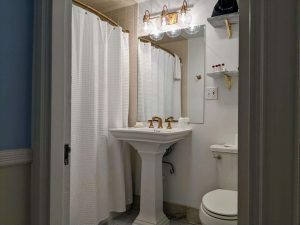 Historic Guest Room With A King Bed | Room 27 11 bathroom pedestal sink room 27 scaled 1 Historic Guest Room with a King Bed | Room 27