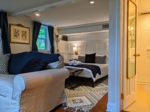 room 1 couch sitting area Queen Bed with Private Entrance: Room 1