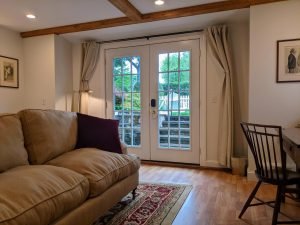 room 2 sitting area couch closed door Private Entrance, King Bed, Close to Pool: Room 2