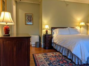 Historic Room With Queen Bed And Spacious Bath: Room 26 10 room 26 dresser fridge bed scaled 1 Historic Room with Queen Bed and Spacious Bath: Room 26