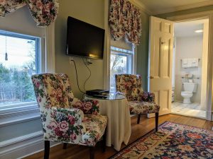Historic Room With Queen Bed And Spacious Bath: Room 26 5 room 26 sitting area tv toilet scaled 1 Historic Room with Queen Bed and Spacious Bath: Room 26