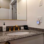 room 28 bathroom sink from shower Fireplace in Room and Private Deck: Room 28
