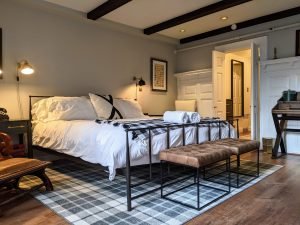 The bathroom is just beyond the bedroom