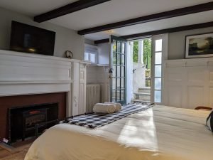 The historic fireplace is one of the coolest features of Room 3
