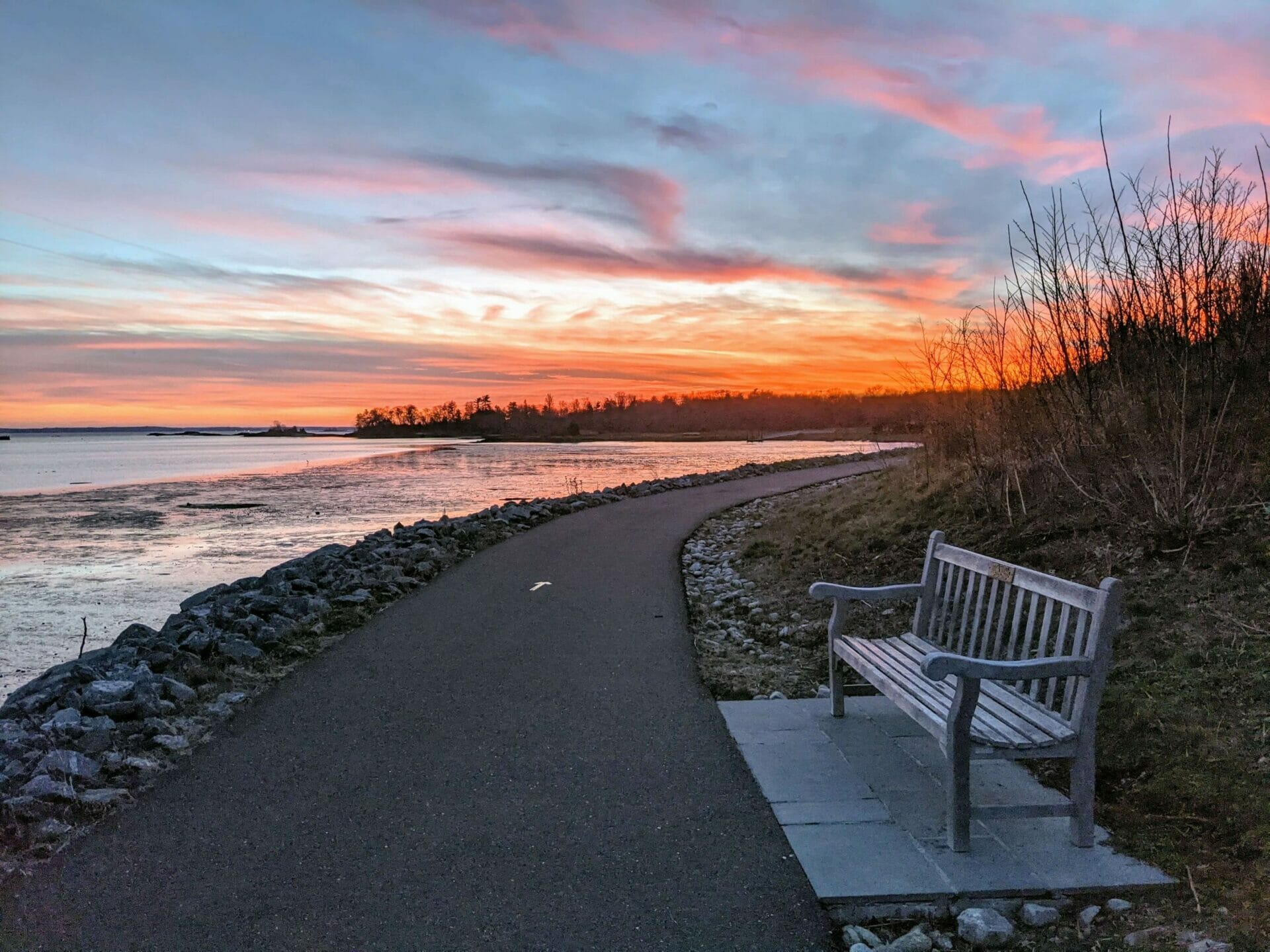 Park bench at sunset at Cos Cob Park