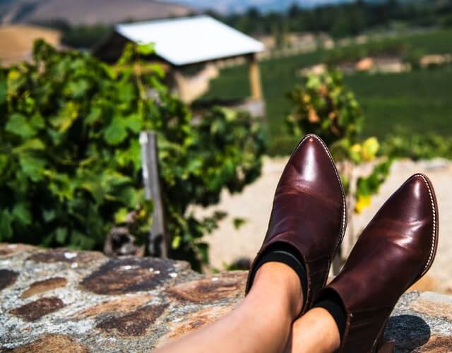 woman putting her feet up at one of the best wineries in CT