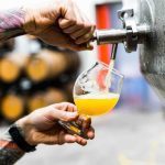 man pouring craft beer from a tap at one of the best Connecticut breweries near Greenwich, CT