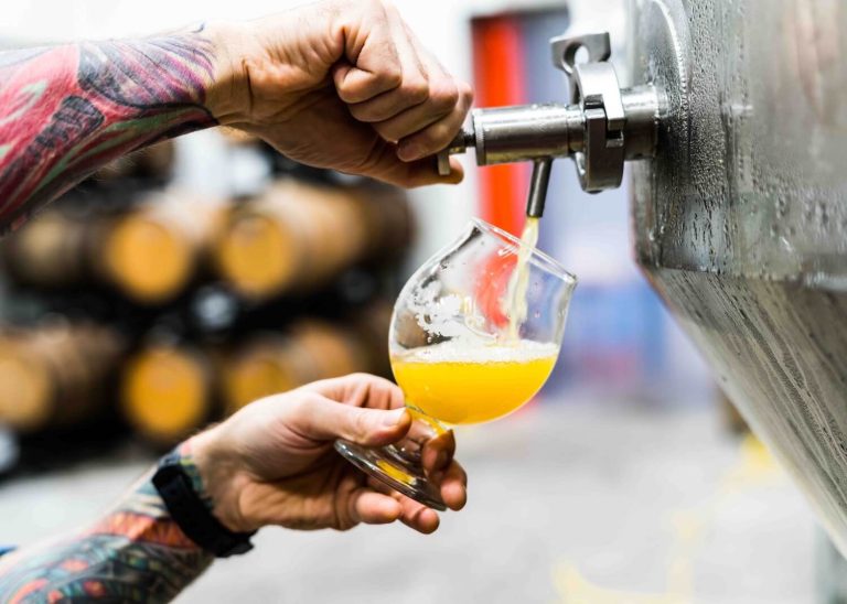 man pouring craft beer from a tap at one of the best Connecticut breweries near Greenwich, CT