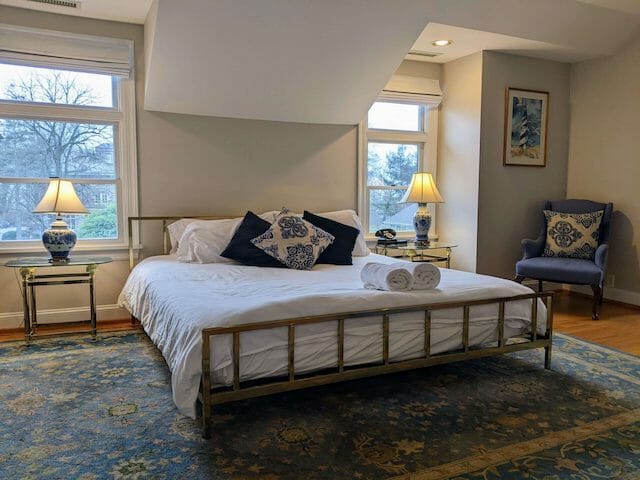 The Sackett Suite features a king sized bed, Whirlpool tub, and sitting area separated from the bedroom by glass French doors.