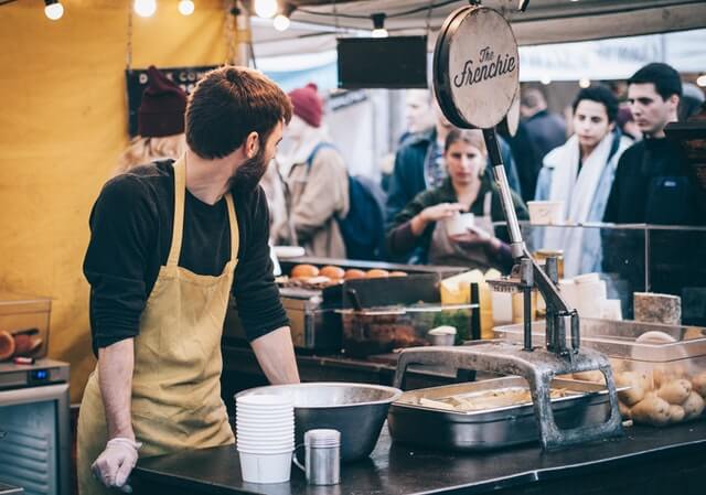 man working at chowdafest, with live music
