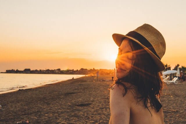 woman admiring the sunset at one of the best ct beaches