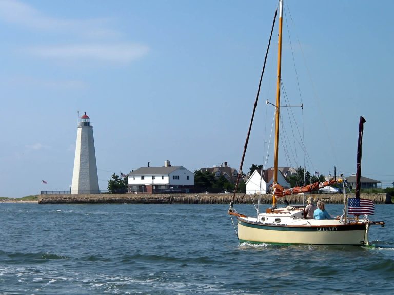 sailing by a lighthouse during summer in CT
