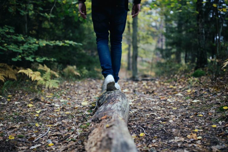 hiker walking on a log on one of the best hiking trails near Greenwich CT