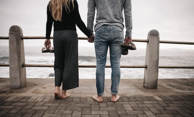 Couple overlooking a cloudy beach
