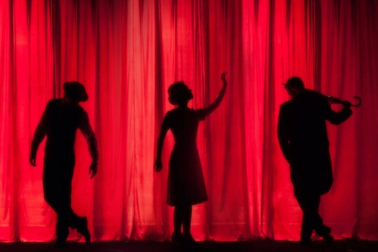 silhouette of actors in front of a curtain at Curtain Call, in Stamford, CT
