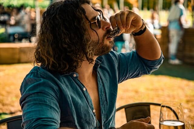 man slurping a raw oyster