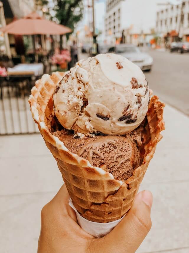 person holding ice cream in greenwich ct on a street
