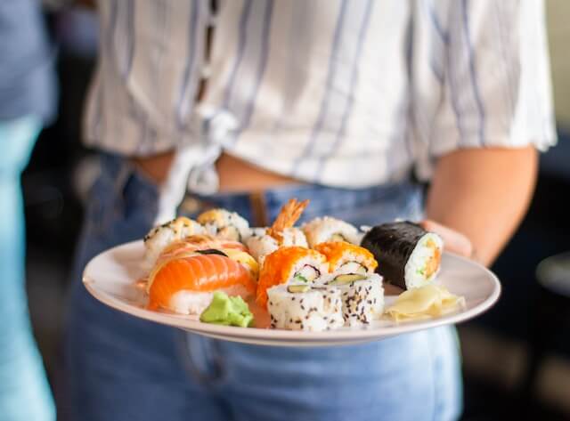 server with sushi at one of the best japanese restaurants in greenwich ct