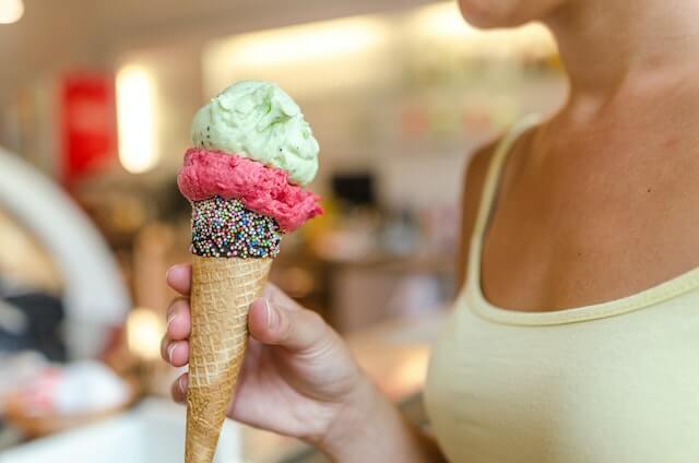 woman holding ice cream in a shop