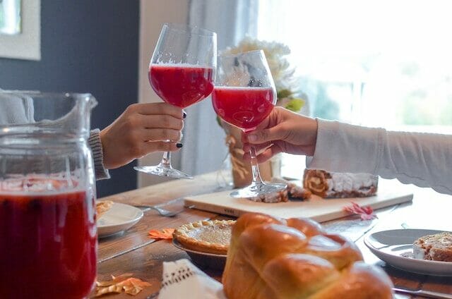 Cheers with glasses of apple wine made into sangria