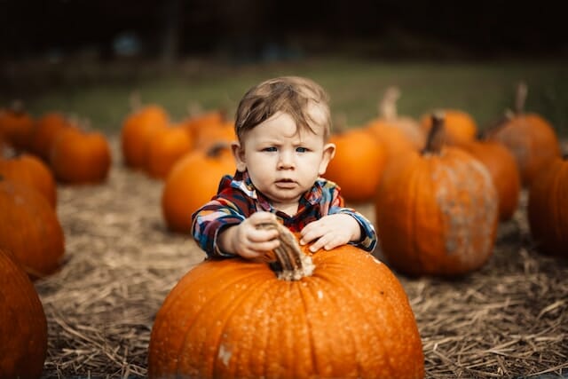 child holding his pumpkin