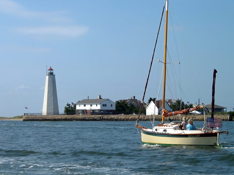 sailing by a lighthouse, one of the most unique things to do in CT