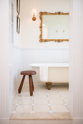 The antique clawfoot tub is in its own room of the bathroom