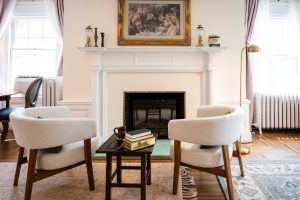 The seating area in front of the antique fireplace in the Brush Suite