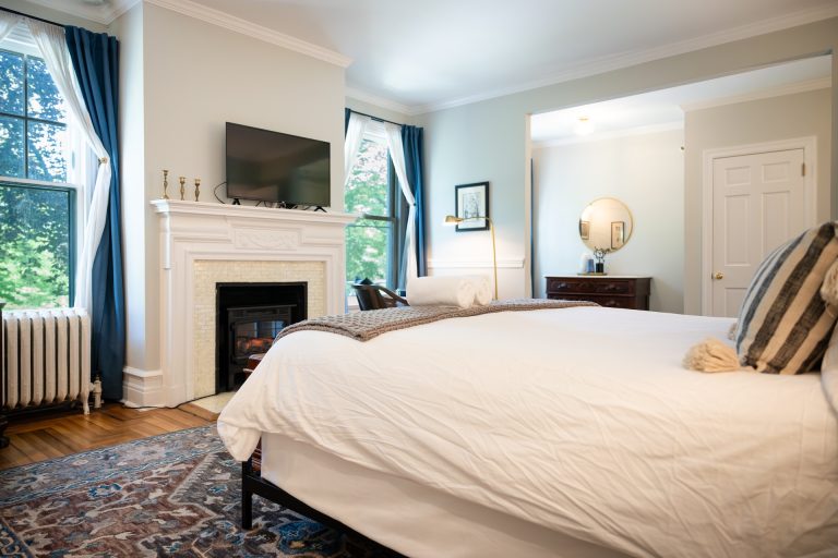 King Bed Suite With Divided Bath: Pomeroy Suite 1 The fireplace and king bed in the Pomeroy Suite, AKA Room 25 at Stanton House Inn