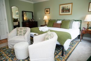 Seating area looking towards the antique dresser and full length mirror in Room 12