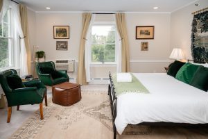 Seating area and bed, looking towards the west window, which faces the back gardens