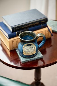 Room 14 mug and stack of books Private Entrance, Fireplace, King Bed: Room 14