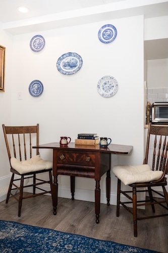 Antique table and chairs in the kitchenette area of Room 5
