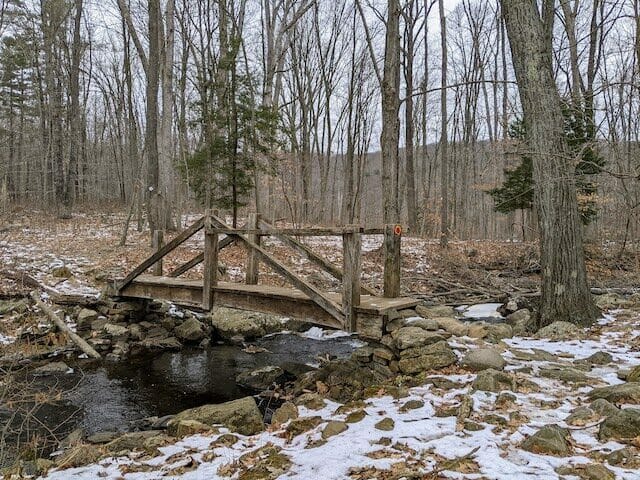 Charming bridge over a stream at Bennett's Pond State Park