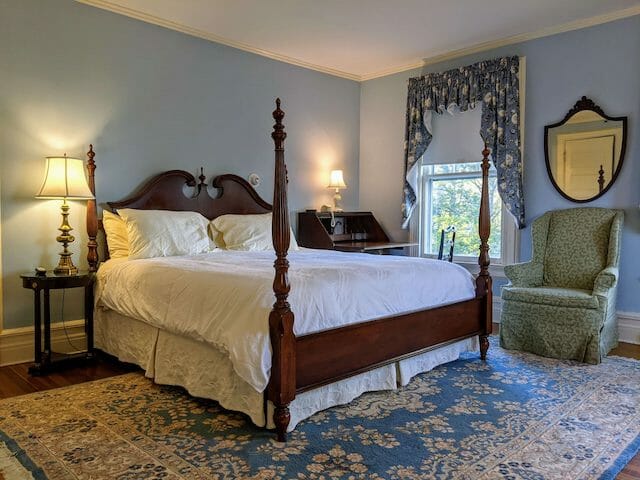 A hotel king sized bed room that's more historic in feel