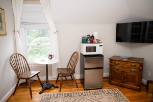 The sitting area includes a cozy spot for dining and work area