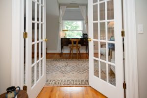Looking through the french doors towards the desk and the window facing the ruins