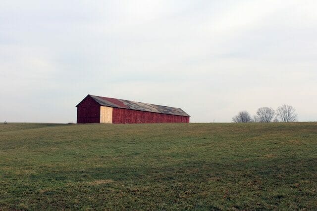 Old red barn on a hill