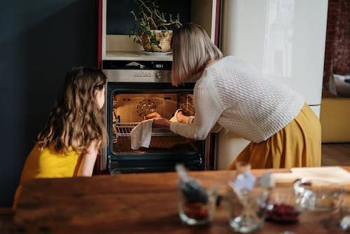 Grandmother showing her granddaughter how to make the Thanksgiving meal