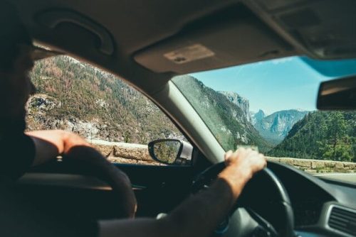 Man driving by beautiful scenery