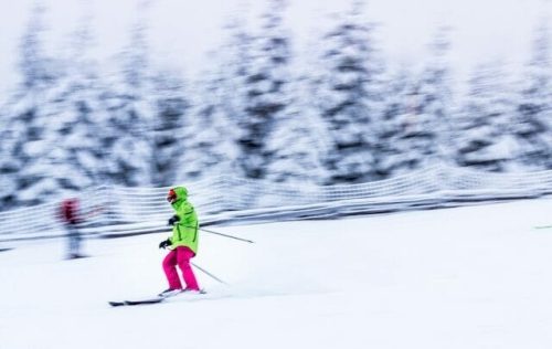 Skiier against a blurred background in a winter wonderland