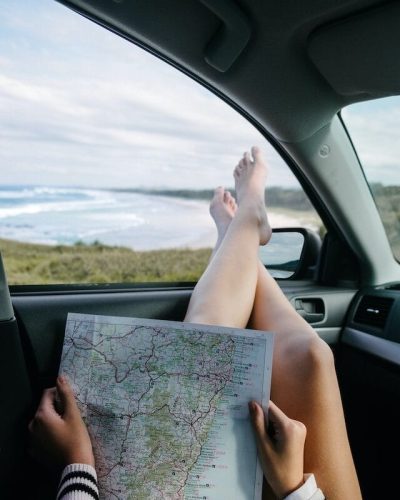 Looking at a map of the road trip route, beach out the window
