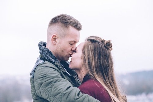 couple embracing on romantic getaways in New England in the winter