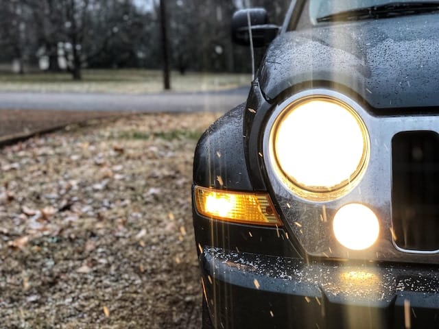 Front lights of a car in the rain