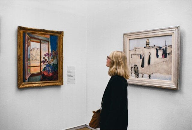 Woman admiring art in an art gallery on a rainy day