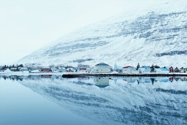 Reflection of a snowy mountain village in Iceland
